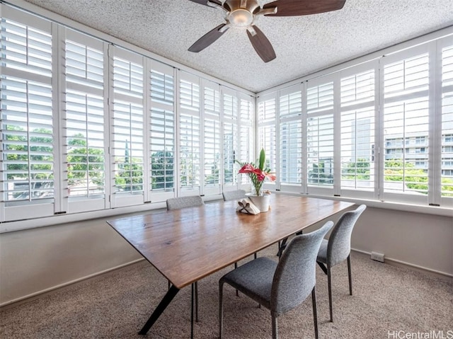 dining space with carpet, ceiling fan, and a textured ceiling