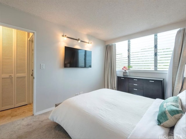 bedroom featuring carpet and a textured ceiling