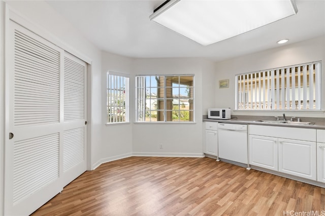 kitchen with white cabinetry, light wood-type flooring, white appliances, and sink