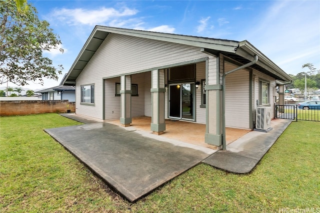 back of property with a patio area, a yard, and ac unit