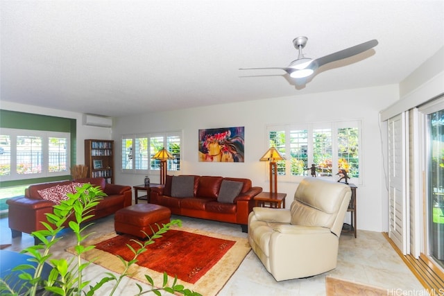 tiled living room with a textured ceiling, a wall unit AC, and ceiling fan