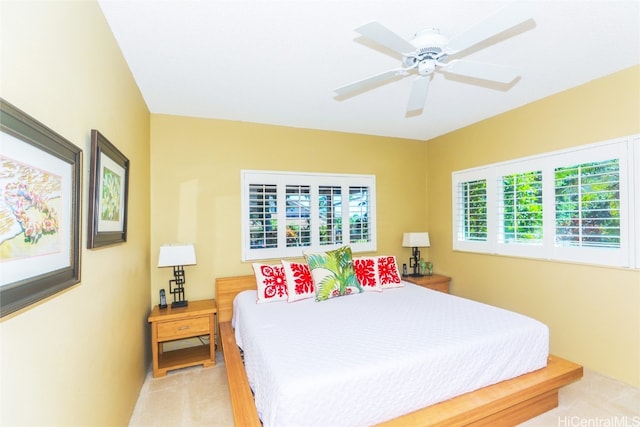 bedroom with light colored carpet and ceiling fan