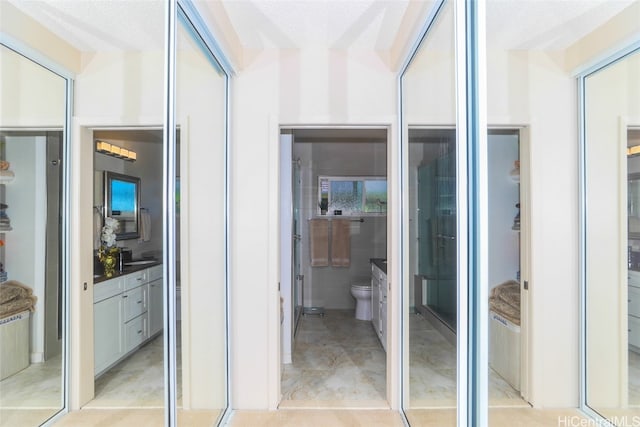 interior space featuring a textured ceiling and toilet