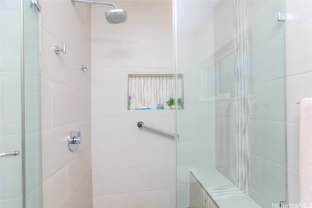 bathroom with a shower with door