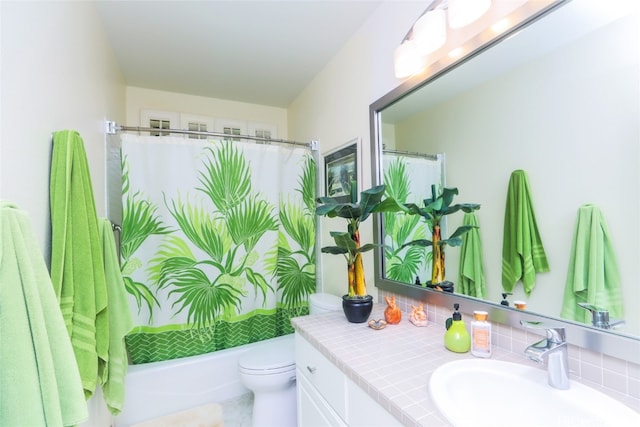 full bathroom featuring shower / bath combo, vanity, and toilet