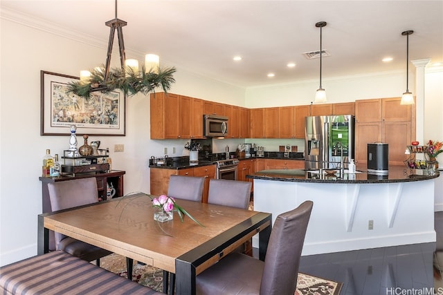 dining space with crown molding, sink, and dark wood-type flooring