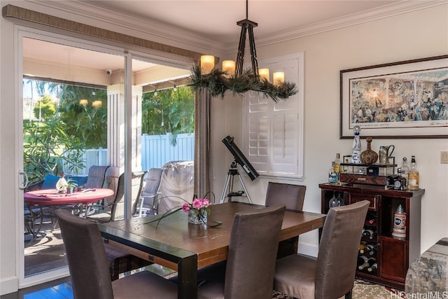 dining area featuring a chandelier and ornamental molding