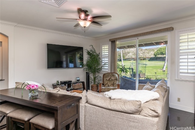 living room with dark hardwood / wood-style floors, ceiling fan, and crown molding