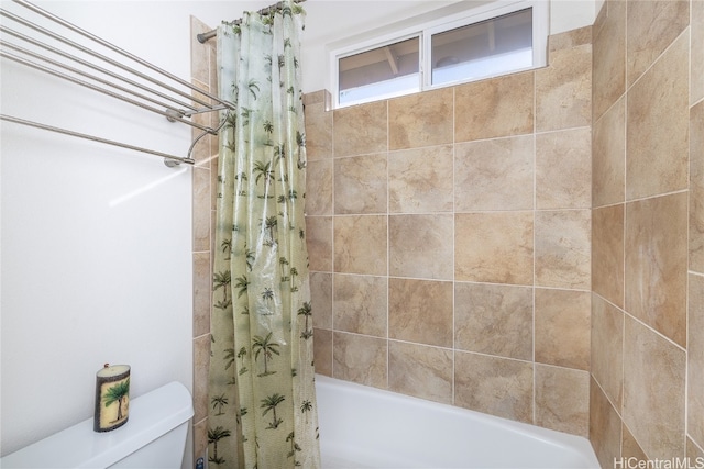 bathroom with shower / tub combo and toilet