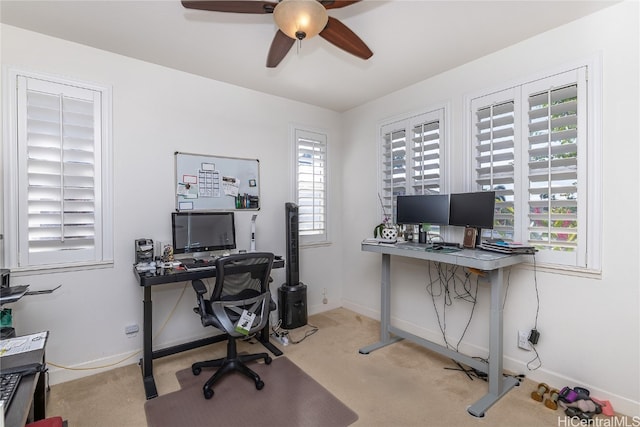 office area featuring light carpet and ceiling fan