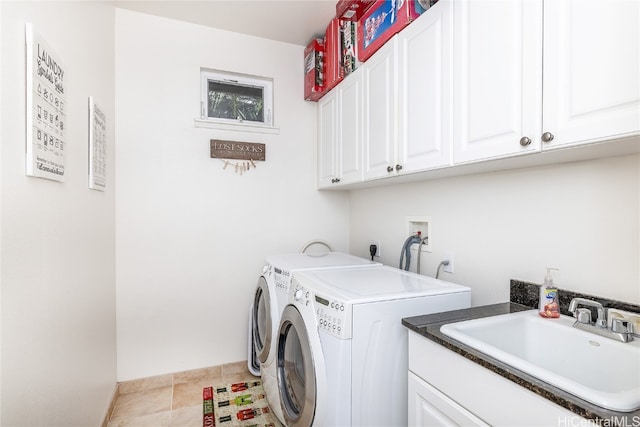 washroom with cabinets, separate washer and dryer, and sink