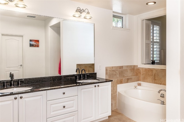 bathroom with vanity and a bathing tub