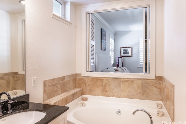 bathroom featuring a bathing tub, a wealth of natural light, vanity, and ornamental molding