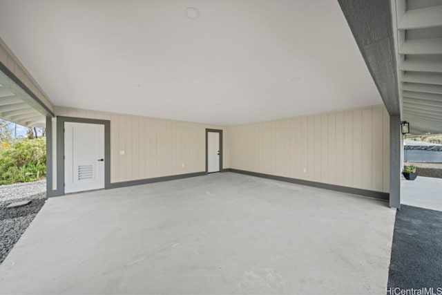 garage featuring wood walls