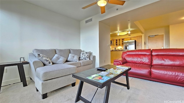 living room featuring ceiling fan and light colored carpet