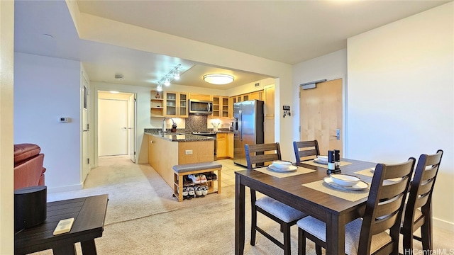 carpeted dining room featuring sink