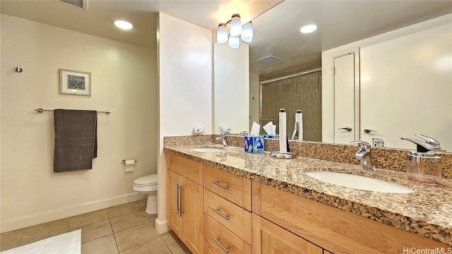 bathroom featuring tile patterned flooring, vanity, toilet, and a shower with door