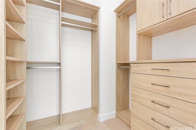 walk in closet featuring light hardwood / wood-style flooring