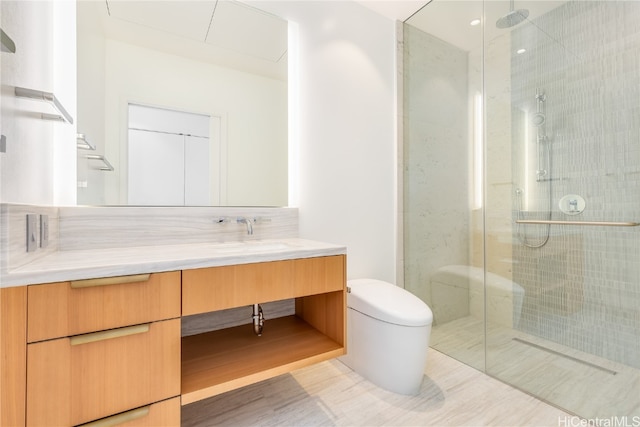 bathroom featuring a shower with door, vanity, and toilet