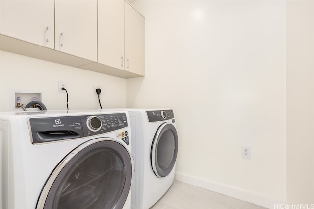 laundry room with cabinets and separate washer and dryer