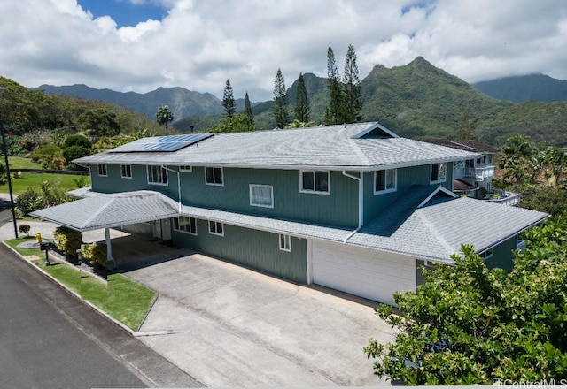 view of property featuring a mountain view and a garage