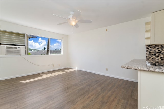 empty room with ceiling fan, cooling unit, and dark wood-type flooring