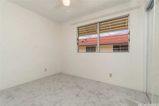 empty room featuring carpet flooring and ceiling fan