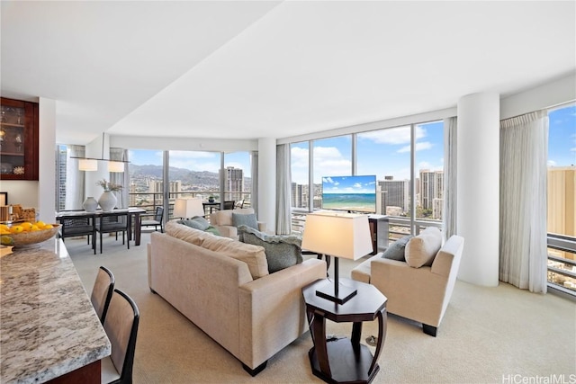 carpeted living room featuring floor to ceiling windows