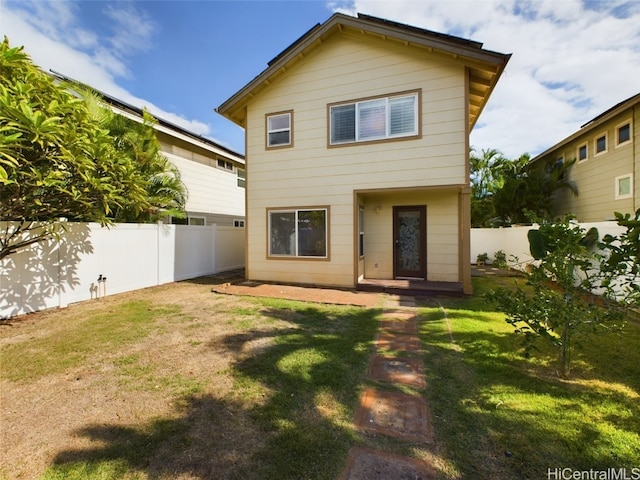 back of house featuring a lawn