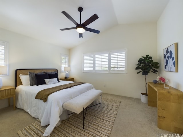 carpeted bedroom featuring ceiling fan and vaulted ceiling