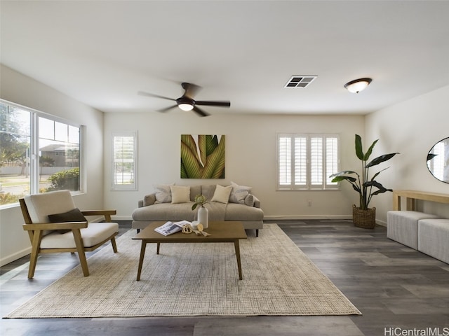 living room featuring dark hardwood / wood-style floors, plenty of natural light, and ceiling fan