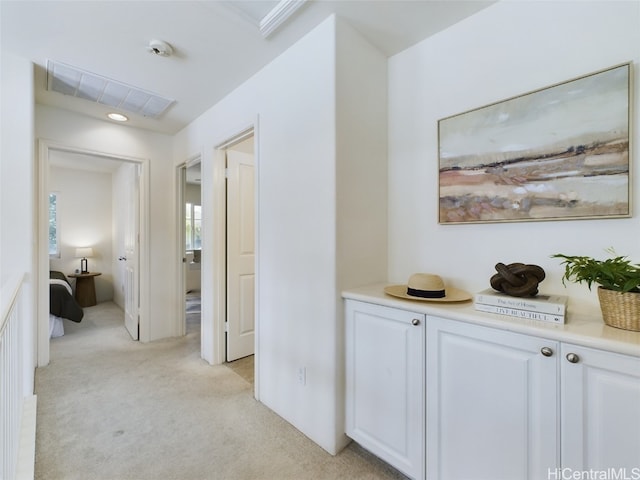 hallway with light colored carpet