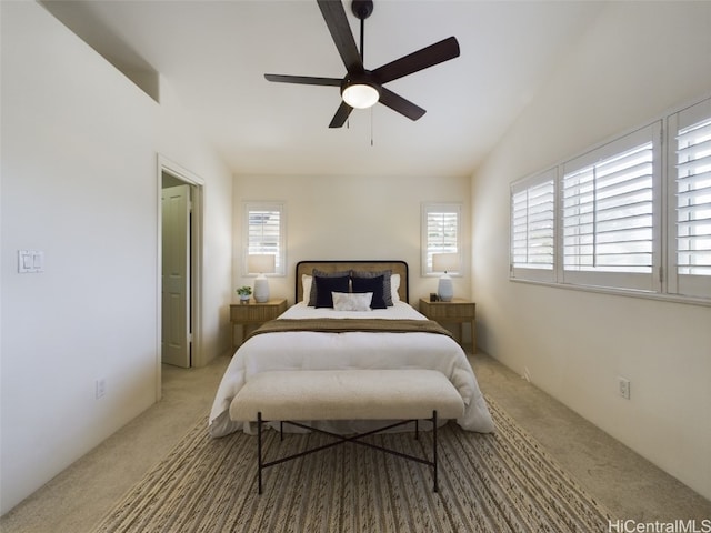 bedroom with carpet flooring, vaulted ceiling, and ceiling fan