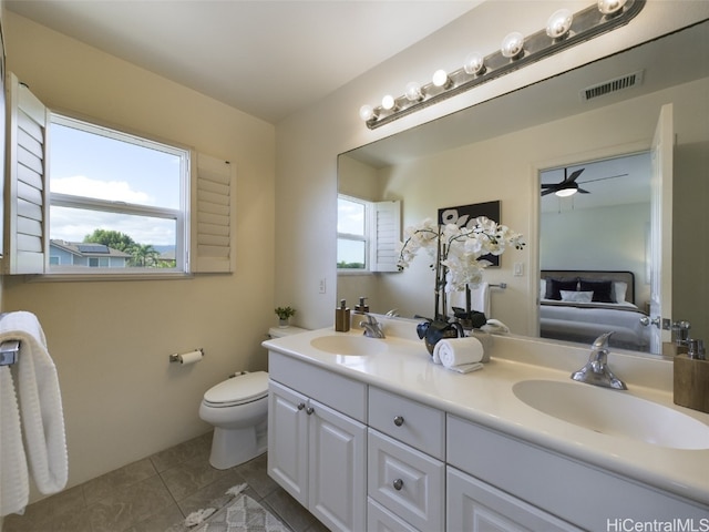 bathroom with tile patterned flooring, ceiling fan, toilet, and vanity