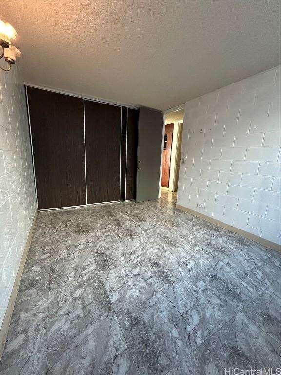 unfurnished bedroom featuring a textured ceiling