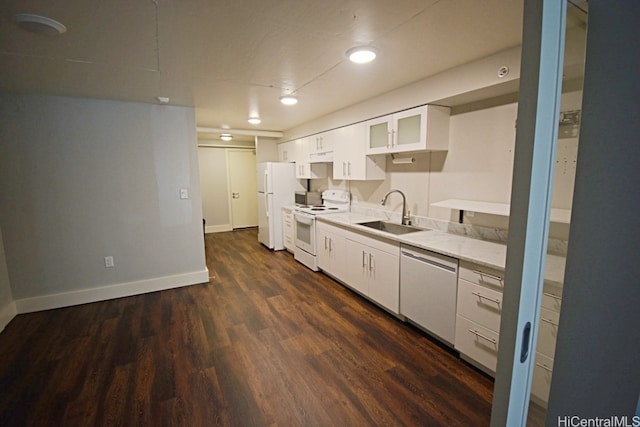 kitchen featuring sink, white cabinets, dark wood-type flooring, and white appliances