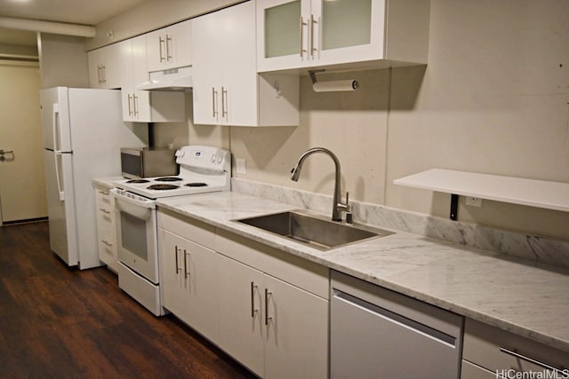 kitchen with light stone countertops, premium range hood, stainless steel appliances, sink, and white cabinetry