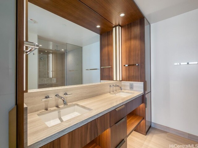 bathroom featuring vanity and a shower with shower door