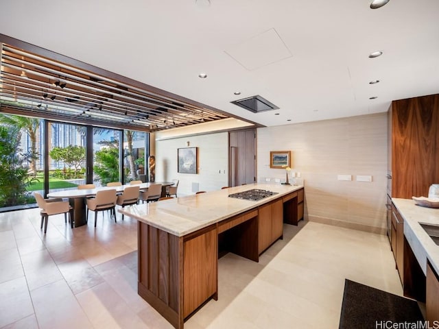 kitchen featuring light stone countertops and stainless steel gas cooktop