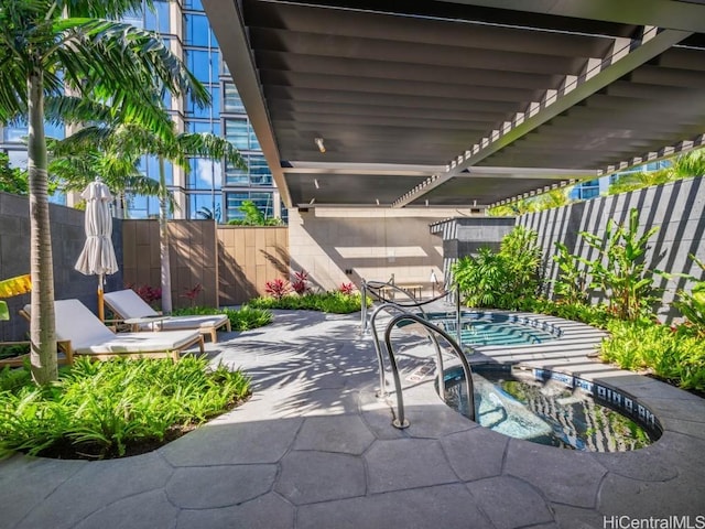 view of patio with a pergola and an in ground hot tub