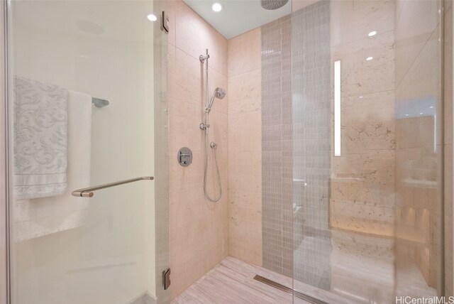 bathroom featuring a shower with door