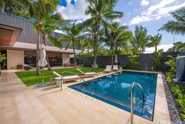 view of swimming pool with a yard and a patio