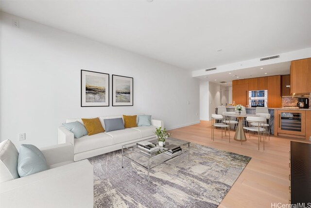 living room with light wood-type flooring and wine cooler