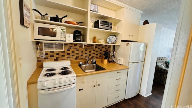 kitchen with white cabinetry, sink, dark hardwood / wood-style floors, a textured ceiling, and white appliances