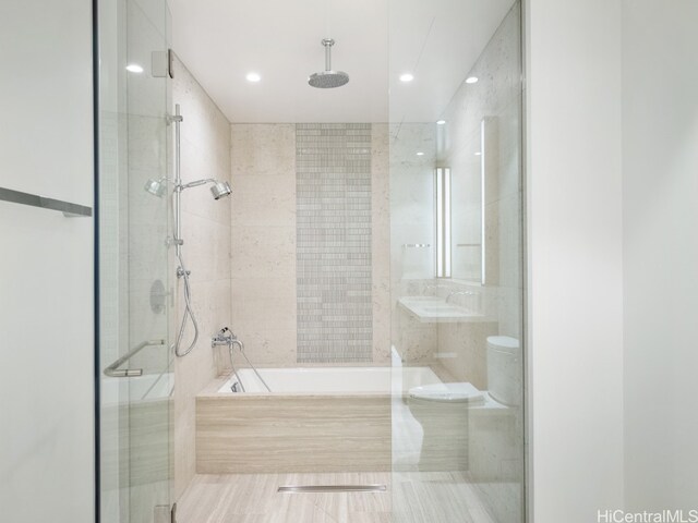bathroom featuring tile patterned flooring, toilet, and independent shower and bath