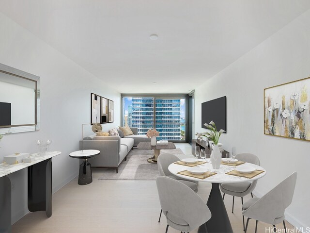 dining room featuring light hardwood / wood-style floors and a wall of windows