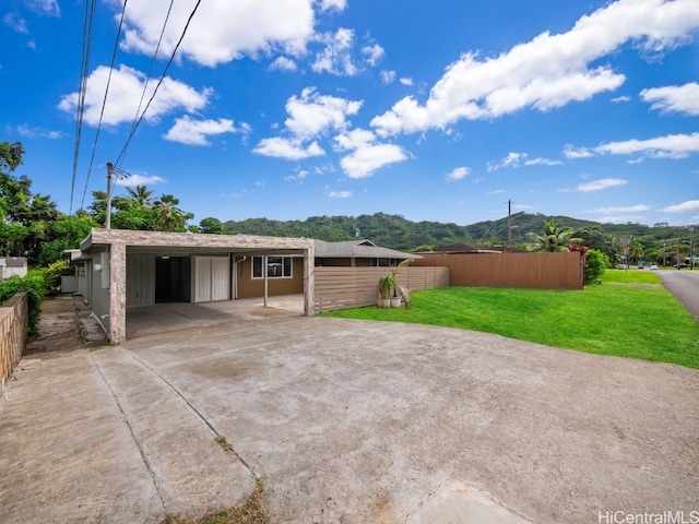 back of property featuring a mountain view and a yard