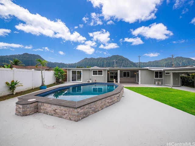 view of pool with a lawn, a mountain view, and a patio