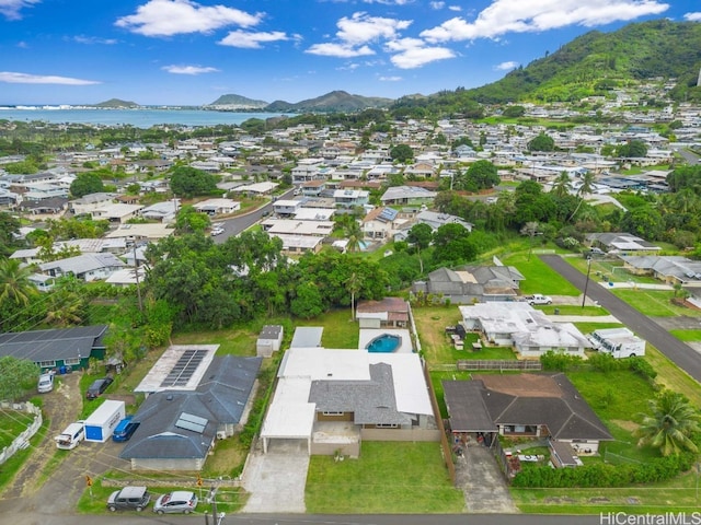 drone / aerial view featuring a water and mountain view