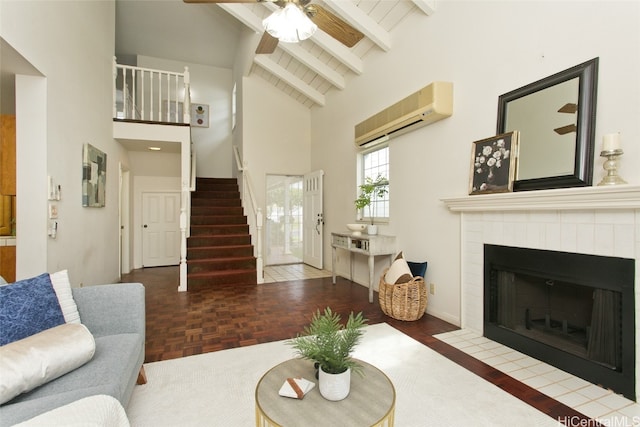 living room with a wall mounted air conditioner, high vaulted ceiling, parquet flooring, a fireplace, and beam ceiling